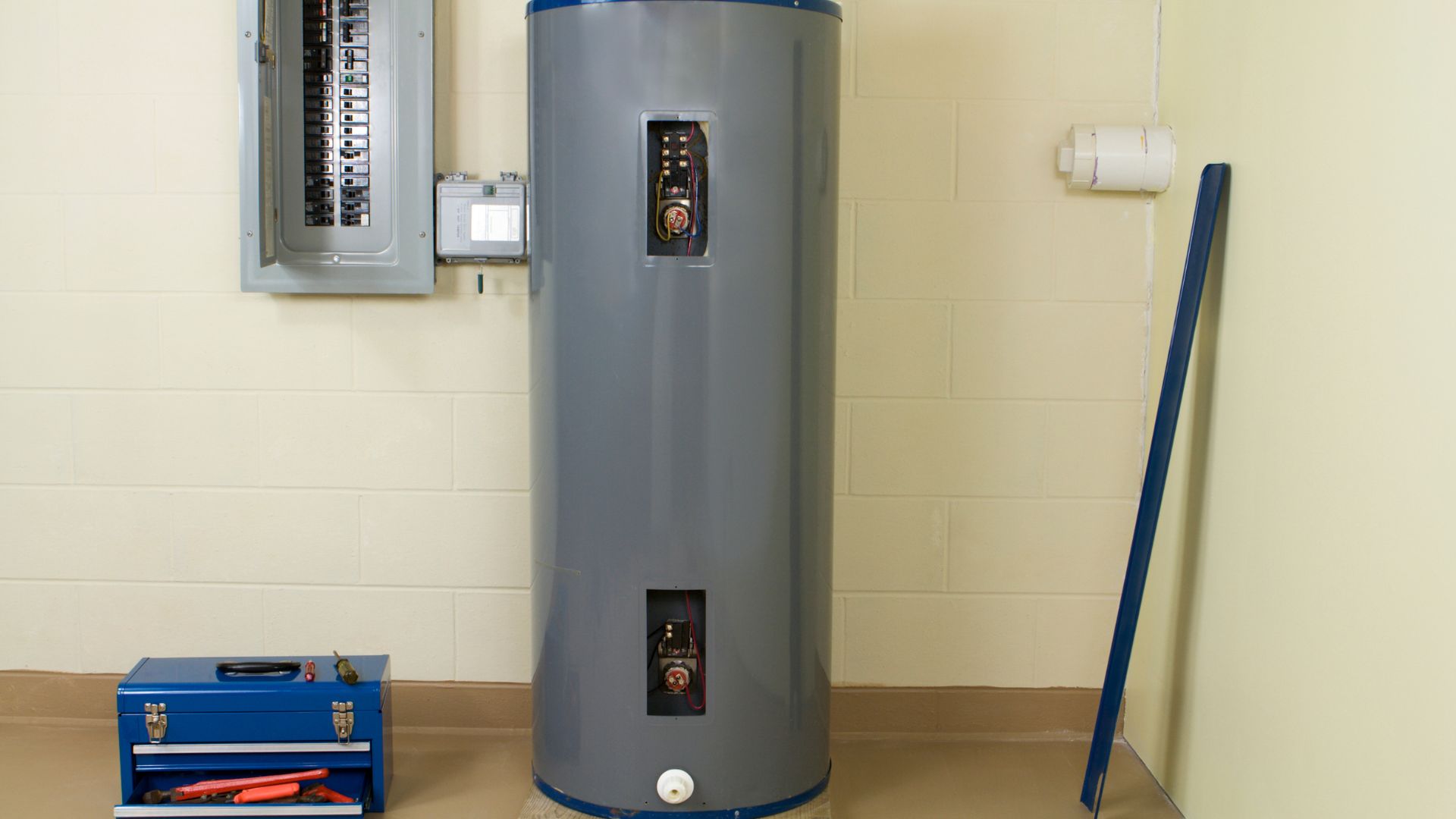 A large water heater sitting next to a wall