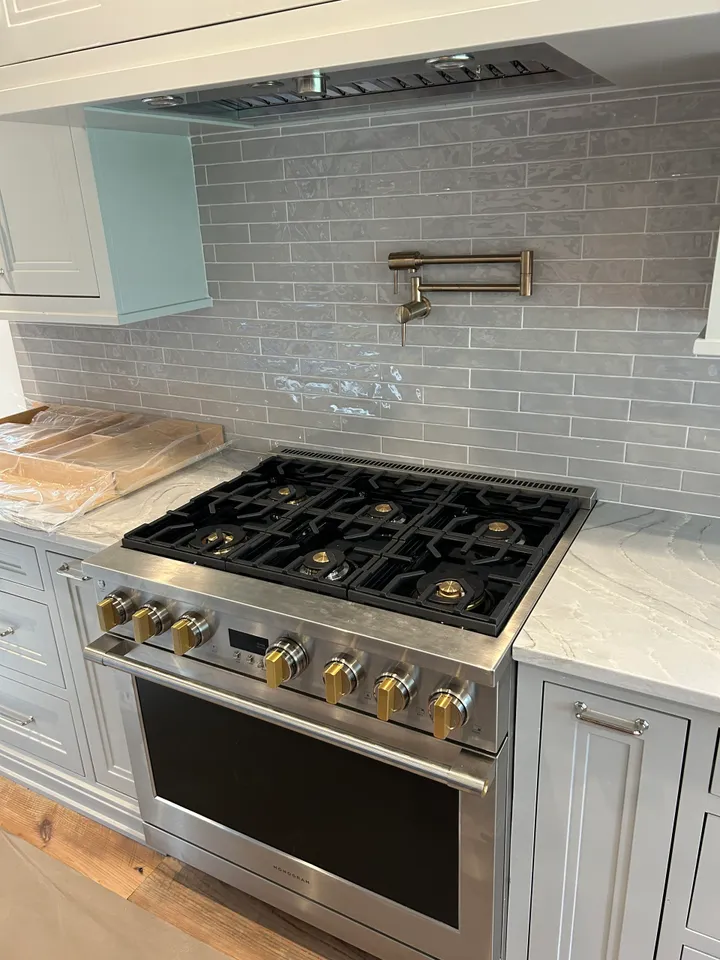 A stove top oven sitting inside of a kitchen