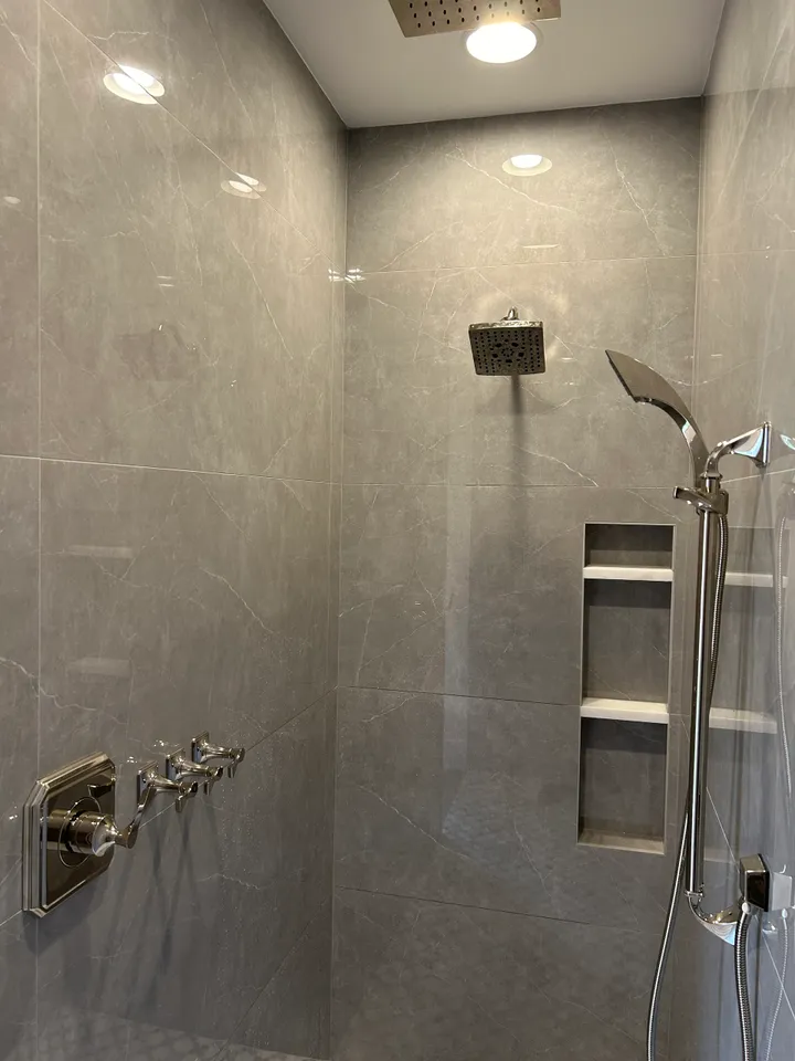 A walk in shower sitting next to a shower head